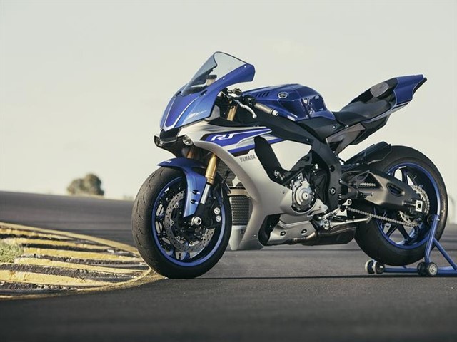 At the centennial EICMA motorcycle show, Yamaha officially unveiled a new generation of R1. It is similar to MotoGP's 2005–Present YZR M1. Yamaha claims a wet weight of 199 kg (439 lb)[13] The new bike has an electronics package that includes a sophisticated Traction Control (TCS) and Slide Control System (SCS), antiwheelie Lift Control System (LIF), linked antilock brakes, Launch Control System (LCS), Quick Shift System (QSS), and selectable power modes.
