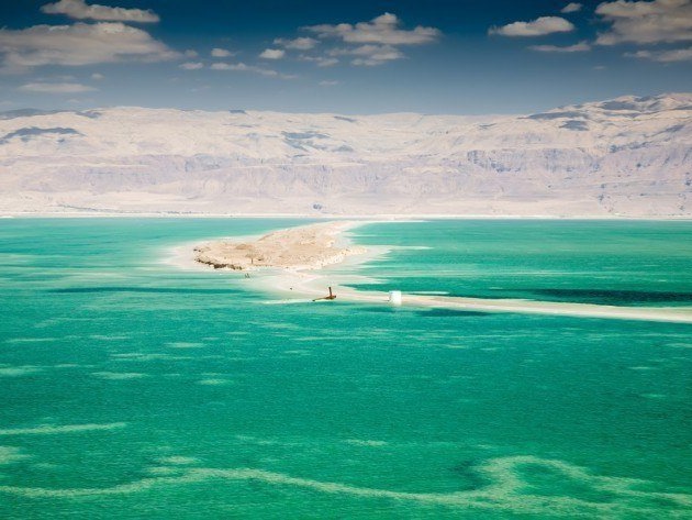 The lowest point on earth borders Israel and Jordan and allows you to experience a natural phenomenon -- floating weightlessly. It's best experienced on the Jordan side, where there are some wonderful resorts to stay at. Its saline waters have attracted visitors for thousands of years, and the surrounding mountains offer a beautiful backdrop.