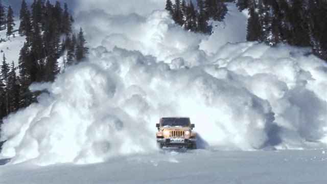 An avalanche is a geophysical hazard involving a slide of a large snow or rock mass down a mountainside, caused when a buildup of material is released down a slope, it is one of the major dangers faced in the mountains in winter. As avalanches move down the slope they may entrain snow from the snowpack and grow in size. The snow may also mix with the air and form a powder cloud. An avalanche with a powder cloud is known as a powder snow avalanche. The powder cloud is a turbulent suspension of snow particles that flows as a gravity current.